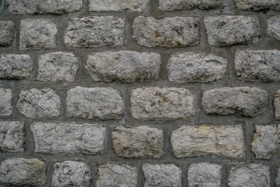 A dry-laid grey stone wall